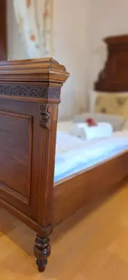 a wooden bed with a wooden dresser in a room at Karst Stone Cottage in Štanjel