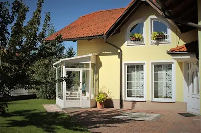 a yellow house with a white door and windows at Yellow Dreamhouse in Postojna