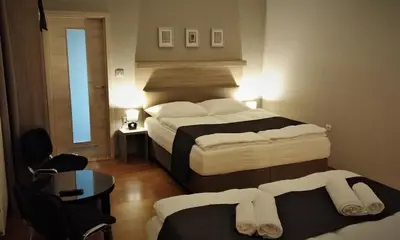 a hotel room with two beds and a window at Yellow Dreamhouse in Postojna