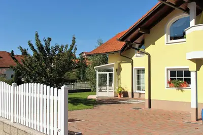 a yellow house with a white picket fence at Yellow Dreamhouse in Postojna