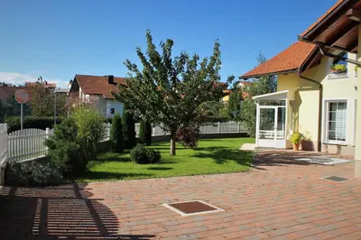 a house with a yard with a brick driveway at Yellow Dreamhouse in Postojna
