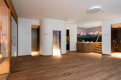 a large room with white walls and wooden floors at Boutique Hotel Grahor in Sežana
