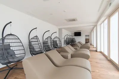 a row of chairs in a room with windows at Boutique Hotel Grahor in Sežana