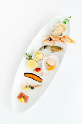 a plate of food with fish and vegetables on it at Boutique Hotel Grahor in Sežana