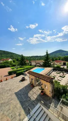 a building with a swimming pool and some stairs at Boutique Hotel Grahor in Sežana