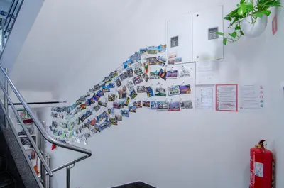 a wall with a bunch of magnets on it at Apartments GreenSLO in Ljubljana