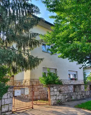 a building with a fence in front of it at Apartments GreenSLO in Ljubljana