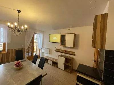 a kitchen and dining room with a table and chairs at Apartma Jelenček in Moravske Toplice