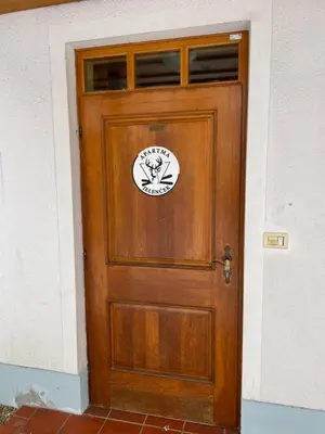 a wooden door with a sticker on it at Apartma Jelenček in Moravske Toplice