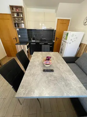 a kitchen with a table and chairs and a counter top at Apartma Jelenček in Moravske Toplice
