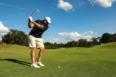 a man swinging a golf club on a green at Villa EVA in Dobrovo