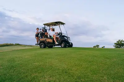 a group of people sitting in a golf cart on a field at Villa EVA in Dobrovo