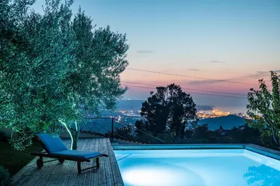 a blue chair sitting next to a swimming pool at Villa EMI in Zgornje Škofije