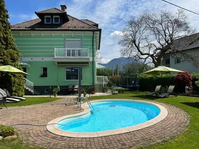 a swimming pool in the yard of a house at Vila Lesce with heated outdoor pool in Lesce