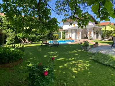 a yard with chairs and a swimming pool at Vila Lesce with heated outdoor pool in Lesce