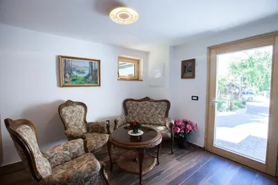 a living room with chairs and a table and a door at Barn House MM in Bled