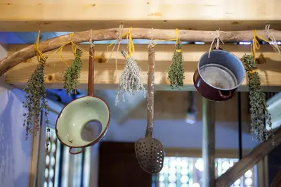 a group of pots and pans hanging from a beam at Barn House MM in Bled