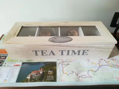 a wooden tea time box on top of a map at Barn House MM in Bled