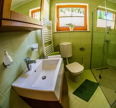 a bathroom with a sink and a toilet at Apartments BBI in Luče