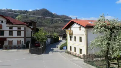 an empty street in a small town with buildings at Holiday House Kanalec in Drežnica