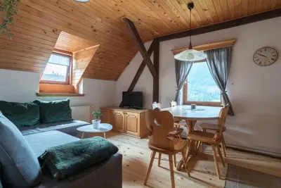 a living room with a couch and a table at Mountain View Apartments - Pr` Potovcn`k in Dovje