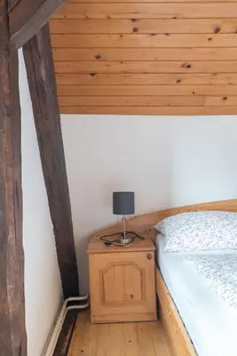 a bedroom with a bed and a lamp on a night stand at Mountain View Apartments - Pr` Potovcn`k in Dovje