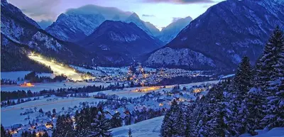 a town in a valley with snow covered mountains at Mountain View Apartments - Pr` Potovcn`k in Dovje