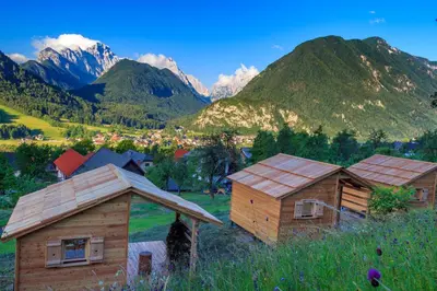 a group of buildings with mountains in the background at Mountain View Apartments - Pr` Potovcn`k in Dovje