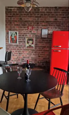 a black table with two glasses and a bottle of wine at Apartment Stella Danica in Čatež ob Savi