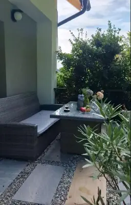 a small patio with a couch and a table at Apartment Stella Danica in Čatež ob Savi