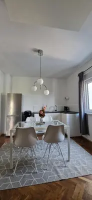 a living room with a table and two chairs at Apartment Stella Danica in Čatež ob Savi