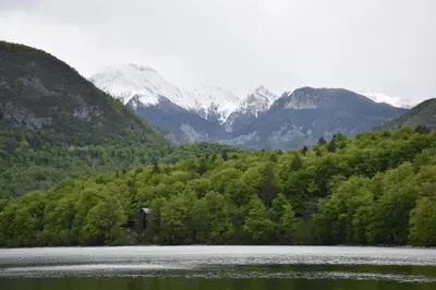 a large body of water with mountains in the background at Apartment Ravnik in Bled