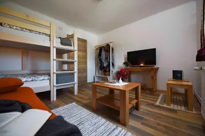 a living room with a bunk bed and a table at Apartment Ravnik in Bled
