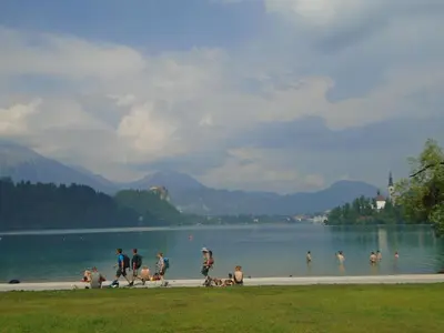 a group of people playing in the water at a lake at Apartment Ravnik in Bled