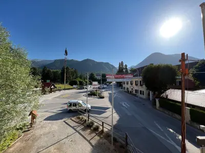 a street with a white truck parked on the side of a road at Guesthouse Avsenik in Begunje na Gorenjskem