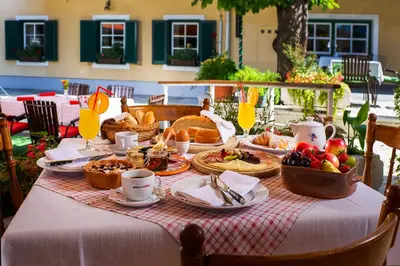 a table with a breakfast of food and fruit at Guesthouse Avsenik in Begunje na Gorenjskem
