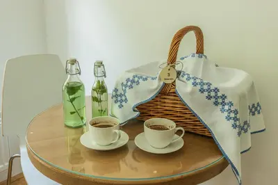 a table with two cups of coffee and a purse at Boutique rooms Pri Rogovilcu in Solčava