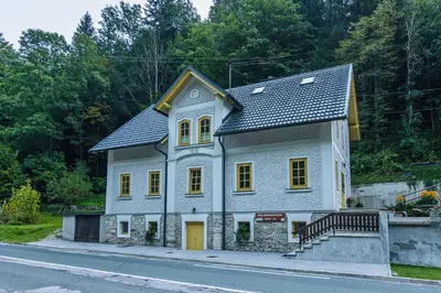 a small house on the side of a road at Boutique rooms Pri Rogovilcu in Solčava