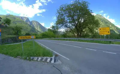 a street sign on the side of a road at Apartma Bel in Žaga
