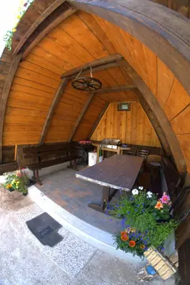 an overhead view of a wooden building with a picnic table at Apartma Bel in Žaga