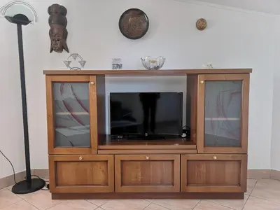 a wooden entertainment center with a flat screen tv at House Čeh in Črni Kal