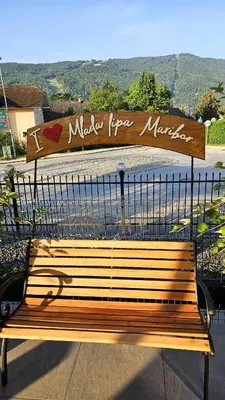 a wooden bench with a sign that reads make fire marias at Guest House Mlada lipa in Maribor