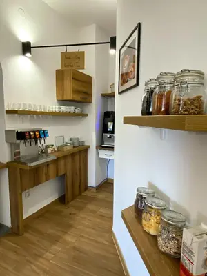 a kitchen with a counter with jars on the wall at Guest House Mlada lipa in Maribor