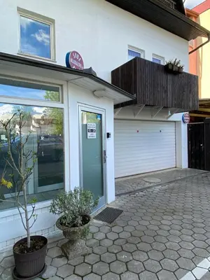 a front door of a building with a garage at Guest House Mlada lipa in Maribor
