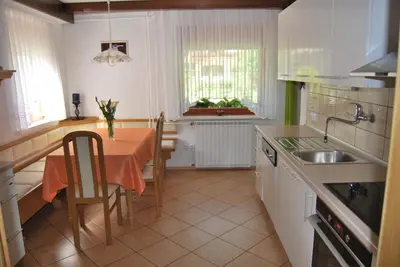a kitchen with a table and a kitchen with a sink at Apartment Stefelin in Kamna Gorica