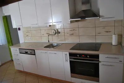 a kitchen with white cabinets and a sink at Apartment Stefelin in Kamna Gorica
