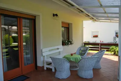 a patio with chairs and a table on a porch at Apartment Stefelin in Kamna Gorica