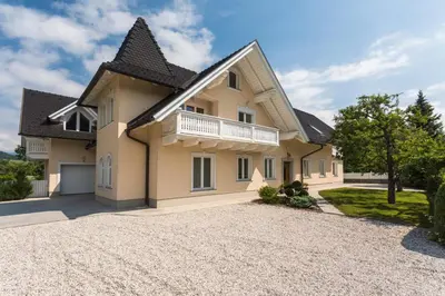 a large house with a gravel driveway at Vila Katja in Bled