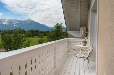 a white balcony with a table and chair on it at Vila Katja in Bled