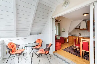 a kitchen and living room with a table and chairs at Vila Katja in Bled